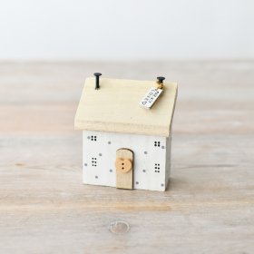 Charming small wooden home with a fresh white finish. 