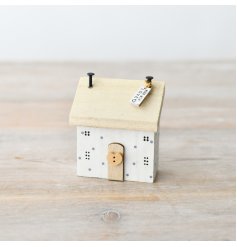 Charming miniature wooden home in pristine white color