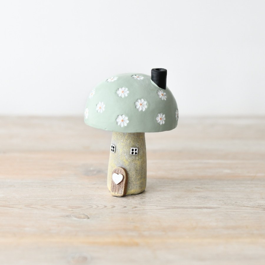 Create a warm and inviting atmosphere with this must-have mushroom house for your cozy home.