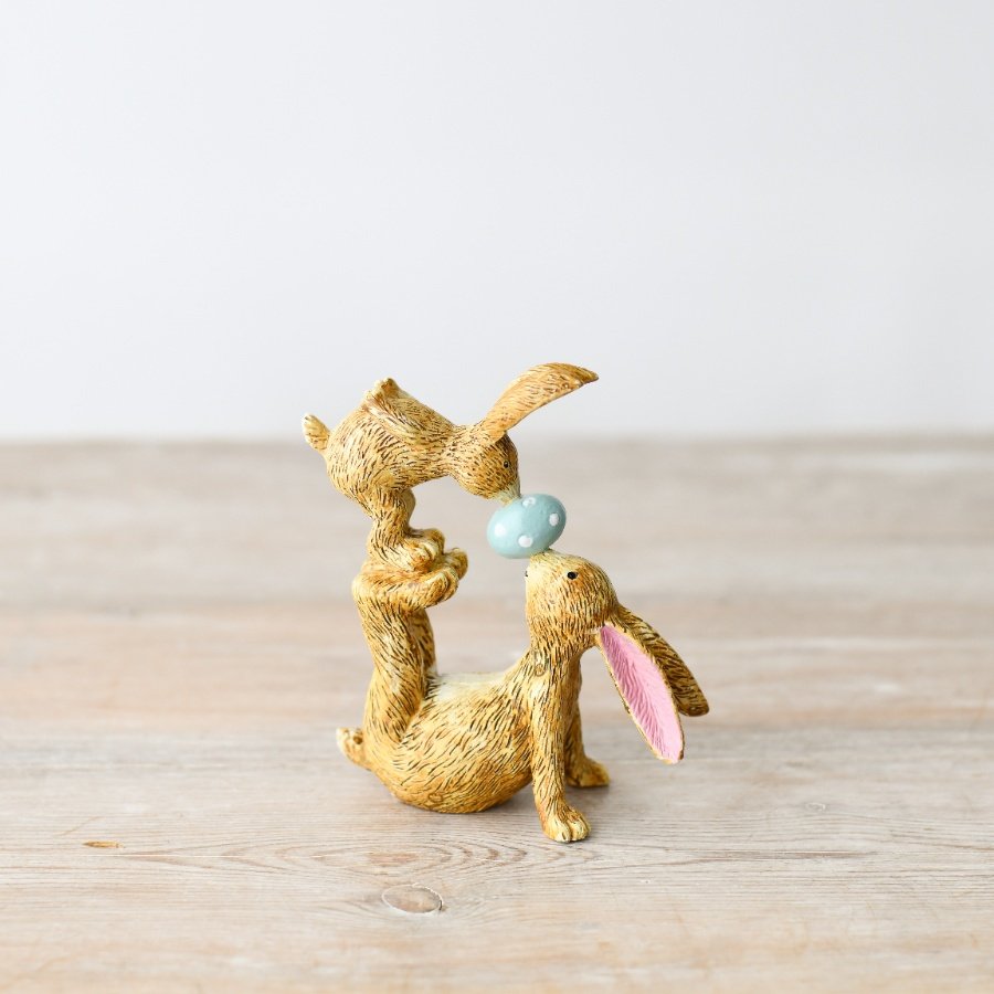 A delightful bunny ornament with exquisite details: two kissing bunnies, pink ears, fur, and nose touches.