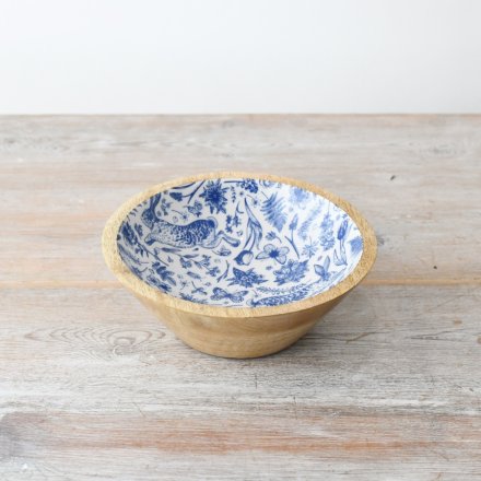 A medium sized wooden bowl adorned with beautiful spring illustrations in a blue and white colour tone, 
