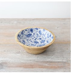 A medium sized wooden bowl adorned with beautiful spring illustrations in a blue and white colour tone, 