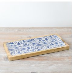 A gorgeous wooden tray featuring blue and white decorative spring patterns 