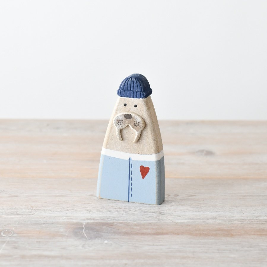 Bring a touch of seaside whimsy to your décor with this charming sea lion figurine 