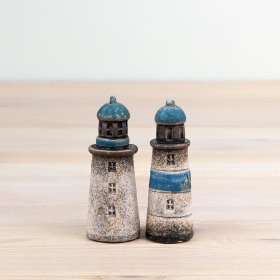 Enhance your interior decor with a charming coastal touch using this adorable lighthouse decoration.