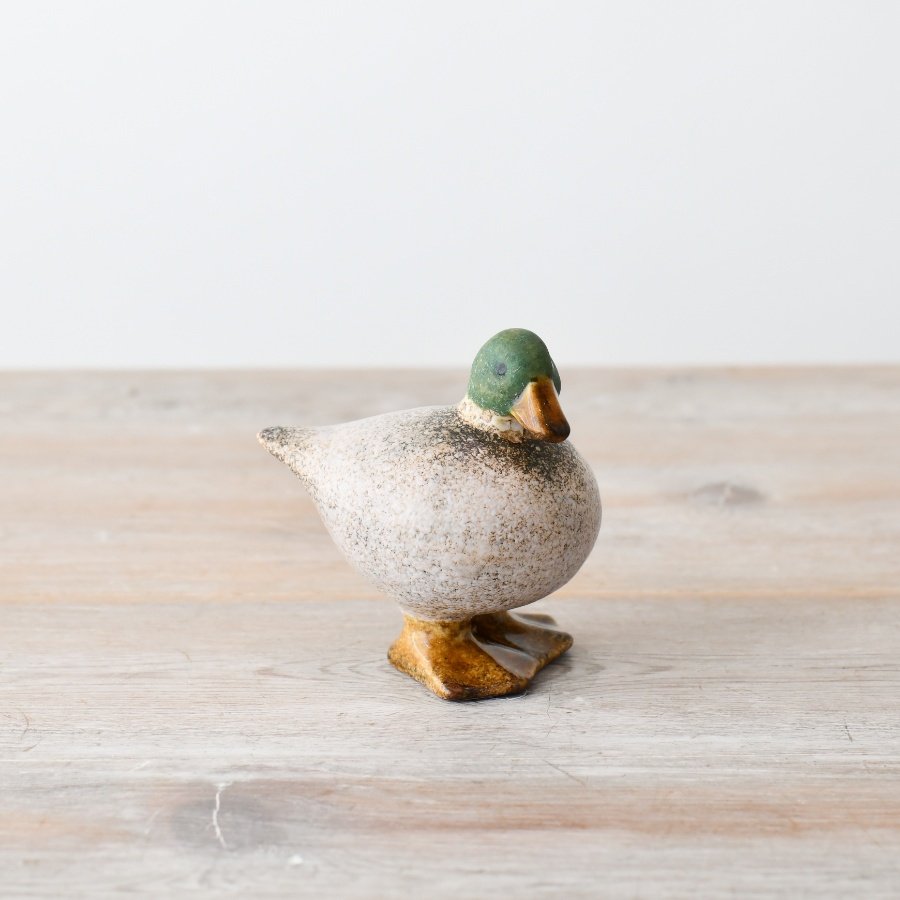 Add a touch of elegance with this charming decorative duck in white and green. Perfect for any space in your home.