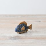 A cute fish ornament with a blue and orange speckle finish 