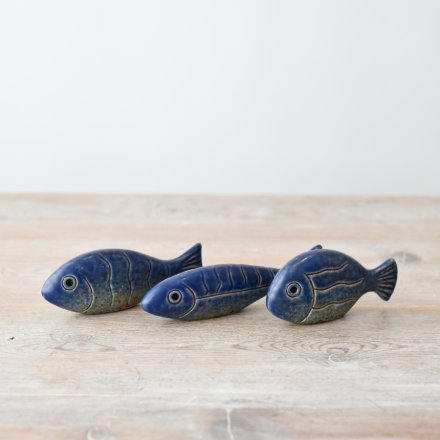 Add a touch of the ocean to your décor with this charming fish figurine