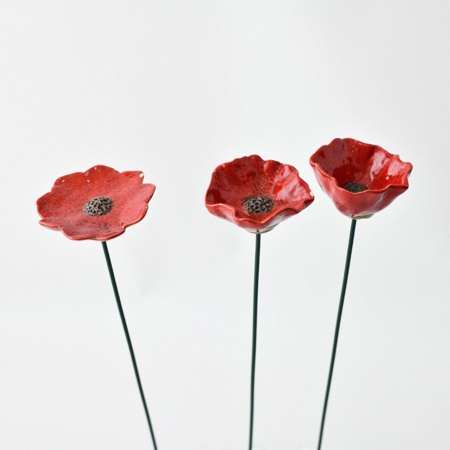 Bring a touch of charm to your garden with our adorable poppy stake - perfect for adding color to flower beds!