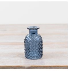 Enhance your space with this charming blue bottle flower vase. Perfect for adding a decorative touch.