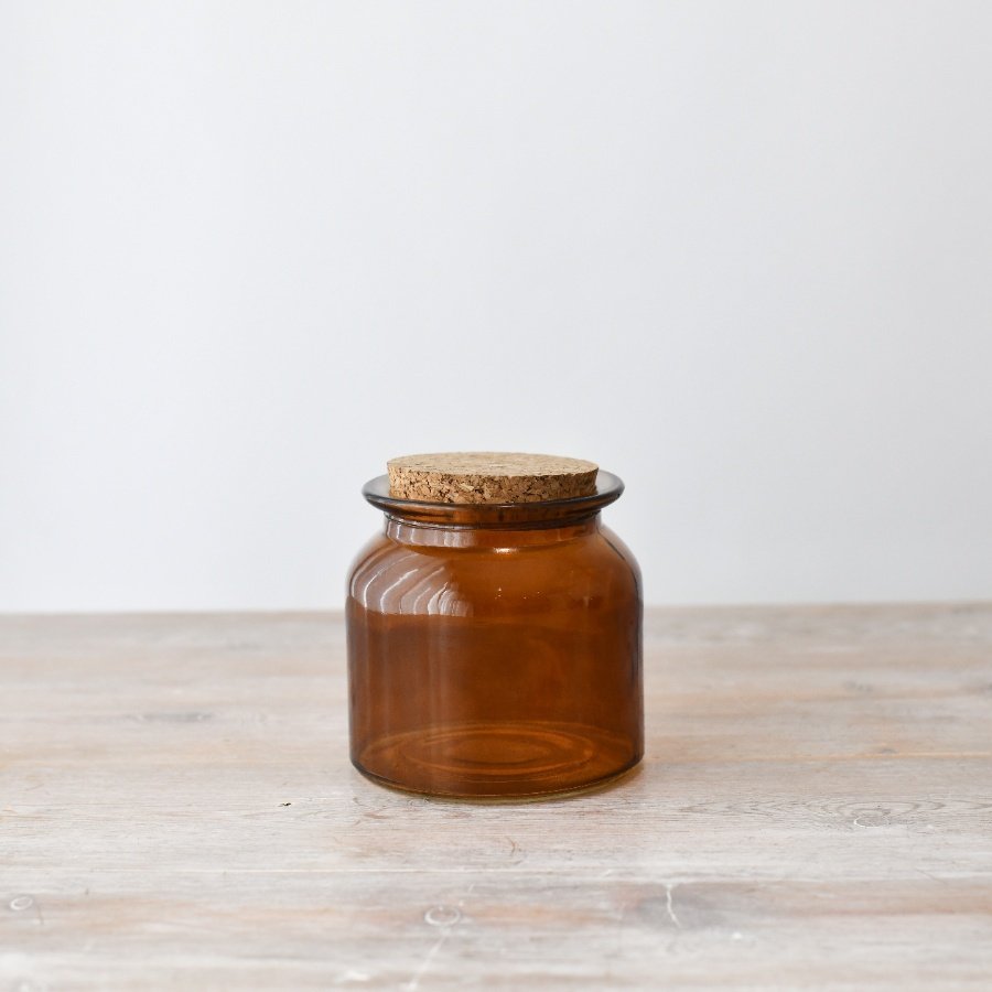 Copper-tinted glass storage jar with painted finish for stylish organization.