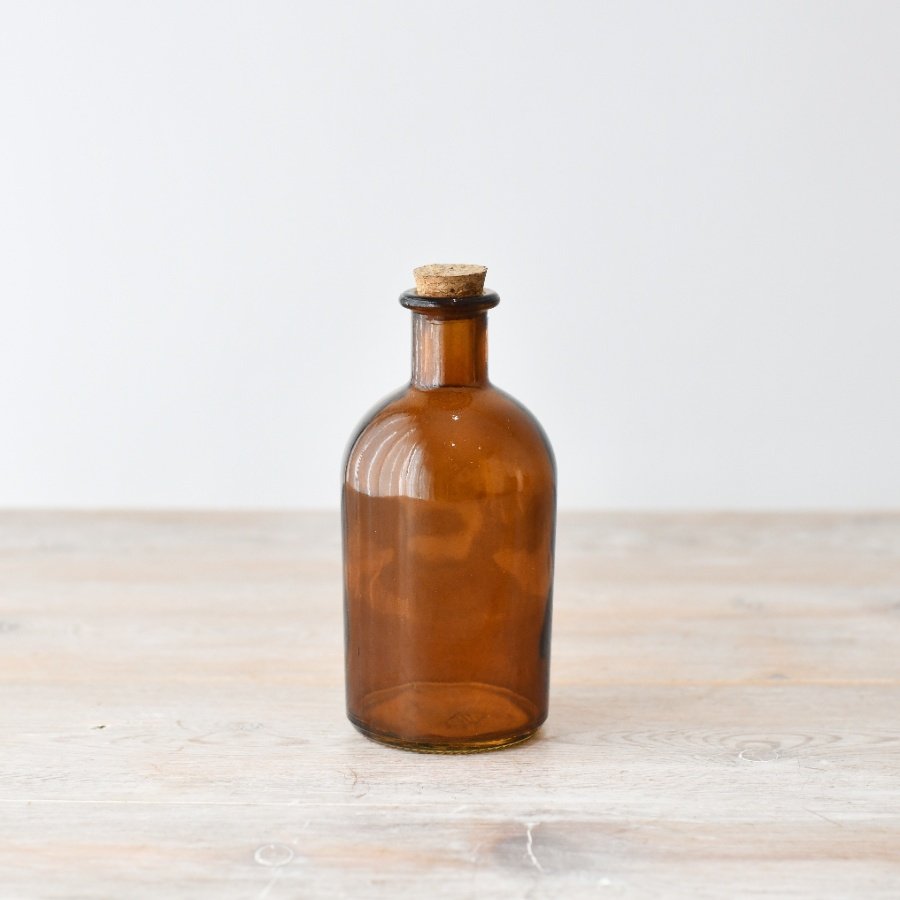 Add elegance to your décor with our stunning Glass Bottle featuring a hand-painted cork.