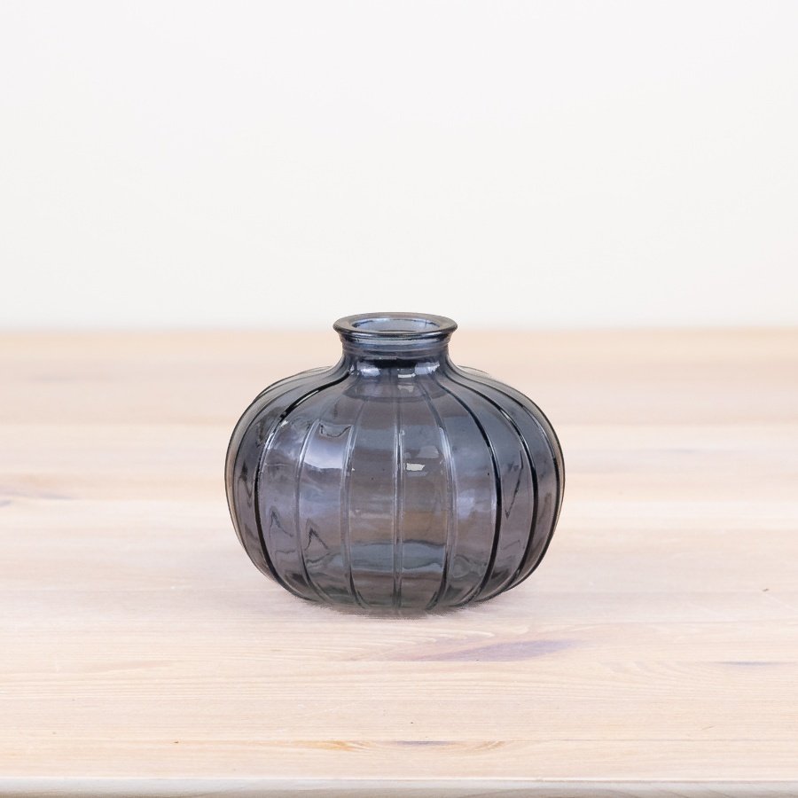 Bring elegance to your home décor with this chic blue vase, lined with intricate detail.