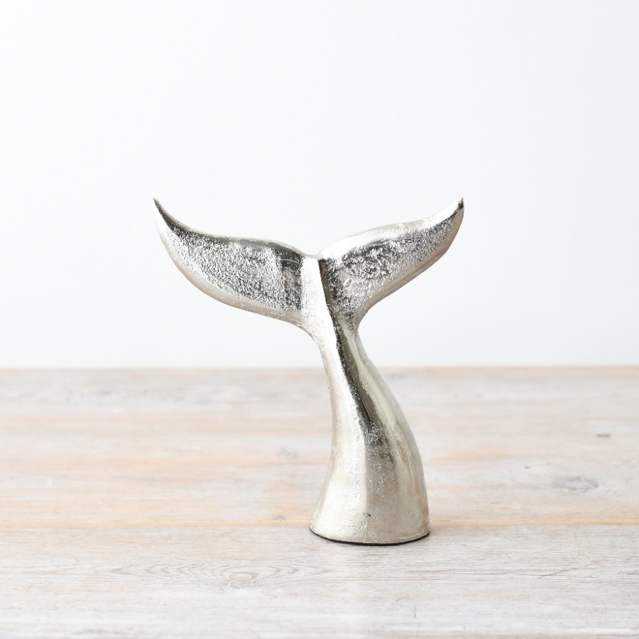 Highlight your home with this coastal whale tail ornament in a sleek brushed silver finish. A perfect statement piece.