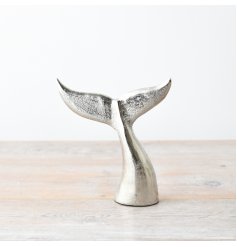 In a brushed silver finish, this coastal whale tail ornament would make a great focal point. 