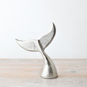 Add a touch of coastal charm with this elegant ornament featuring a vertical whale's tail in a brushed silver finish.