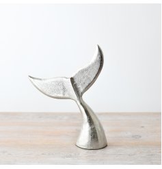 A gorgeous coastal ornament featuring a whales tail stood vertical in a brushed silver effect.