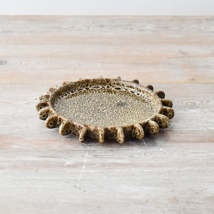 Elevate your home decor with this stunning stoneware plate in beautiful neutral tones.