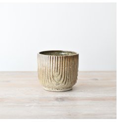 Create a charming home for your plants with this rustic planter. Perfect for any household greenery.