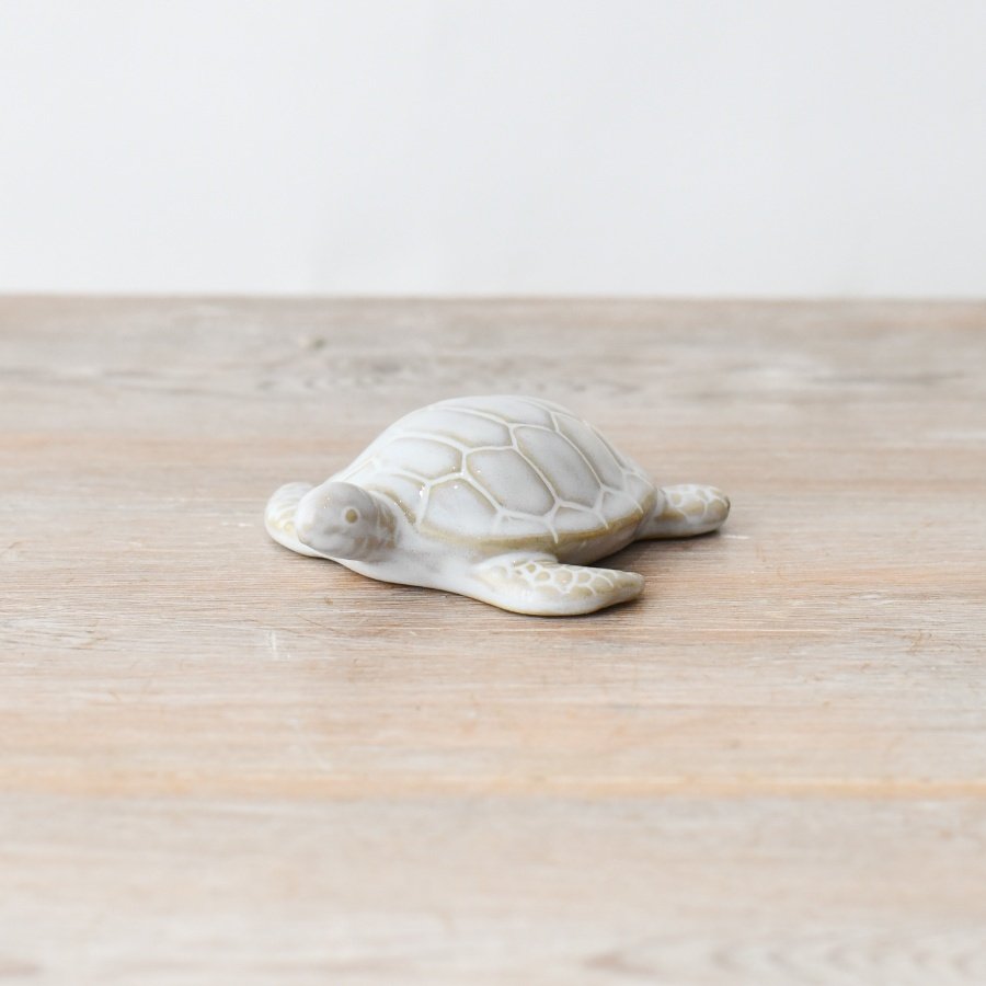 Add a little seaside charm to your decor with this adorable turtle figurine