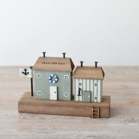 "Embrace coastal living with the "Seas The Days" wooden house, perfect for your seaside getaway. 