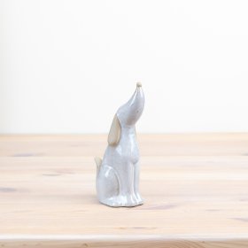 "Delicate porcelain dog ornament with charming black bow - a must-have for any dog enthusiast!"