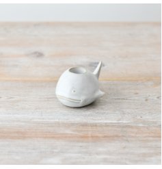 Create a seaside vibe with this elegant whale-shaped candle holder.