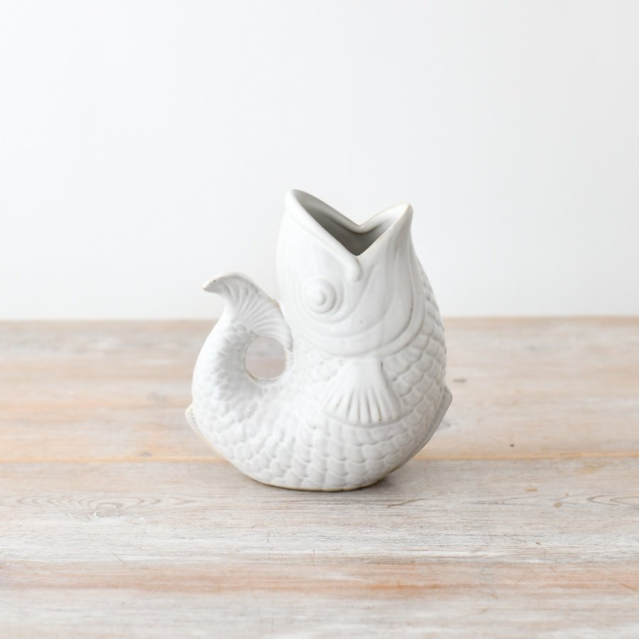 "Add a touch of elegance to your space with our white fish vase, beautifully designed and glazed for a sleek finish. 