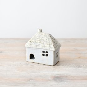 Add some charm to the interior decor with this adorable light-up house ornament featuring a traditional thatched roof.