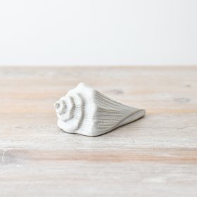 Elevate your home decor with this elegant and unique shell ornament.