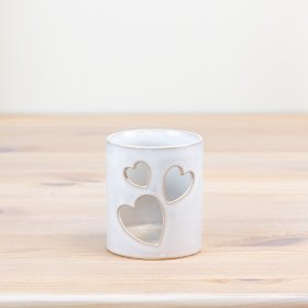 Adorable candle pot with charming heart design - perfect for adding a cozy touch to any space. 