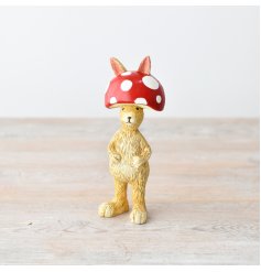 Add playful charm to your decor with our whimsical Rabbit in Mushroom Hat figurine. 