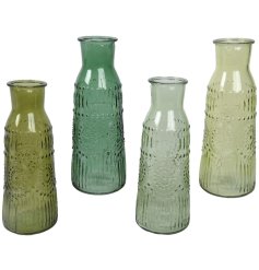 Infuse your decor with charm using these trendy bottle vases - the perfect addition to any space