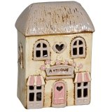 Add a touch of elegance and warmth to your home with our Cream Candle House.