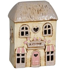 Add a touch of elegance and warmth to your home with our Cream Candle House.