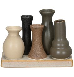 A beautifully crafted platter featuring 5 small vases in an assortment of neutral colours. 