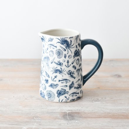 A gorgeous coastal jug adorned with patterns of sea creatures, shells and anchors.