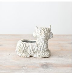 Add a touch of rustic charm to your garden with our Laying Down Highland Cow Planter