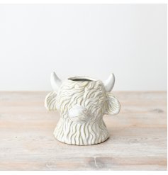 Beautiful planter featuring a delightful white highland cow design.