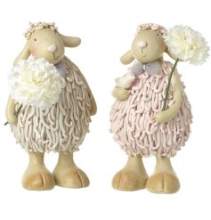 Decorate your home for spring with 2 sheep ornaments adorned with delicate white flowers. A charming addition to any d