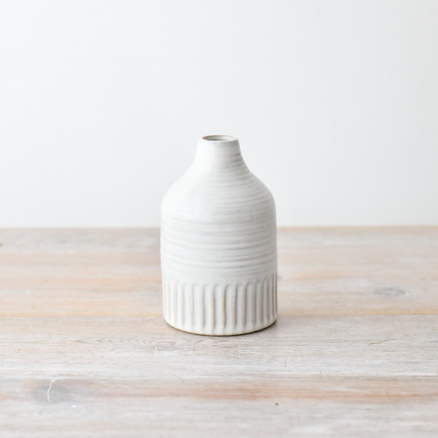 Elegant white soma vase with graceful tall neck adds charm to any room decor.