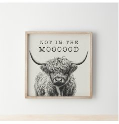 A fun and cute wooden frame featuring a shaggy highland cow with scripted text above.