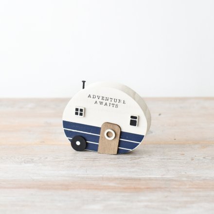 A rustic wooden camper ornament with a coastal coloured design and scripted text.
