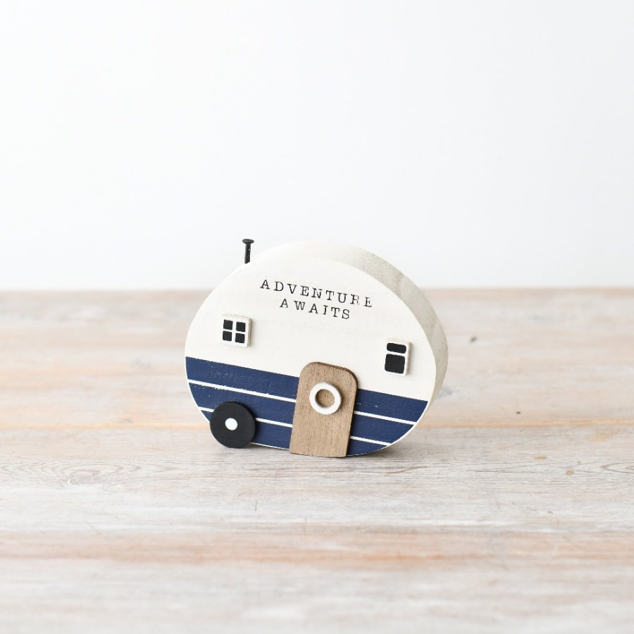 "Add charm to your decor with a coastal-inspired camper ornament, featuring a rustic wooden finish and stylish scripte