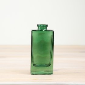 Tall, green glass bottle vase. Perfect for showcasing fresh flowers or as a decorative piece.