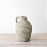 A rustic large jug made from terracotta with a textured surface in a chic neutral colour. 