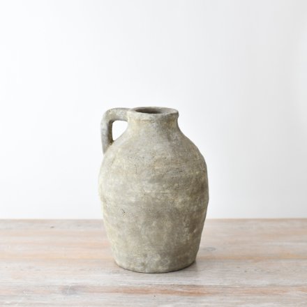 A rustic large jug made from terracotta with a textured surface in a chic neutral colour. 