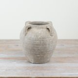 A gorgeous stone vase with 4 decorative handles, perfect for creating a statement piece in the home.