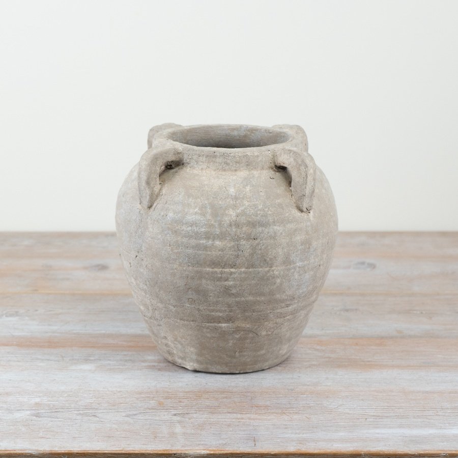 Make a statement with this stunning stone vase featuring 4 decorative handles, ideal for any home decor.