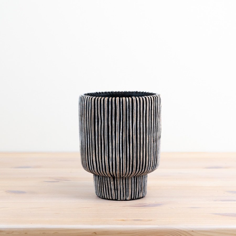 Black & cream planter boasts a stunning lined design for a touch of elegance in any space. 